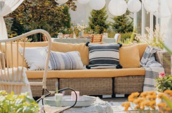 real-photo-of-a-yellow-garden-sofa-with-a-table-6AEYZQ9